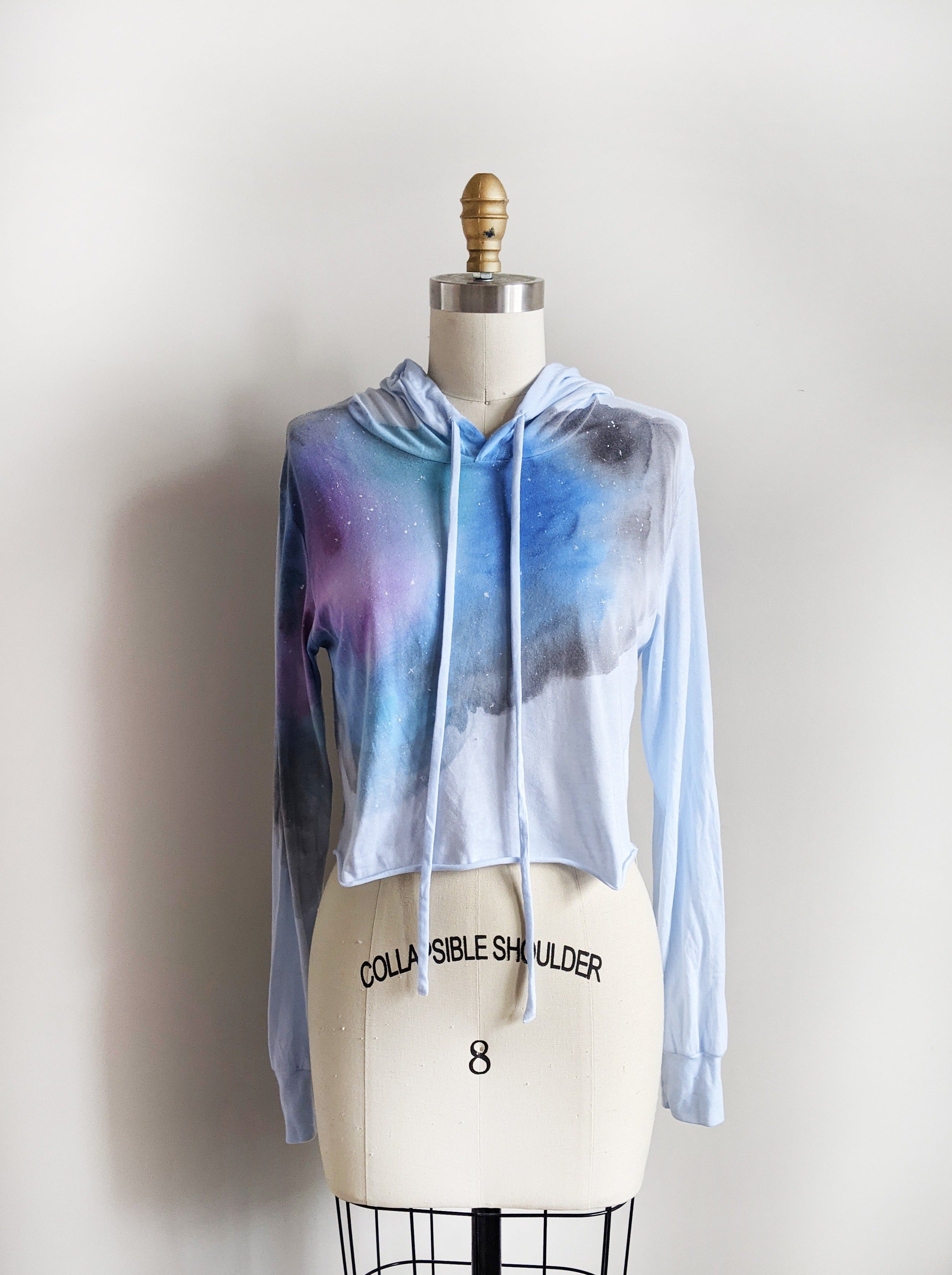 The trendy raw hem is the perfect long-sleeve hooded shirt to bring you into the spring and summer.