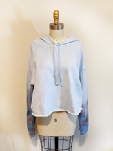 Load image into Gallery viewer, Let fashion and comfort take over your wardrobe with this great statement piece. The trendy raw hem is the perfect long-sleeve hooded shirt to bring you into the spring and summer.
