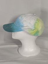 Load image into Gallery viewer, Add a splash of color to your wardrobe and your adventures. A fun nod to space, this abstract and tie-dye inspired updated take on the classic dad hat offers plenty of shade and loads of comfort no matter where you roam.
